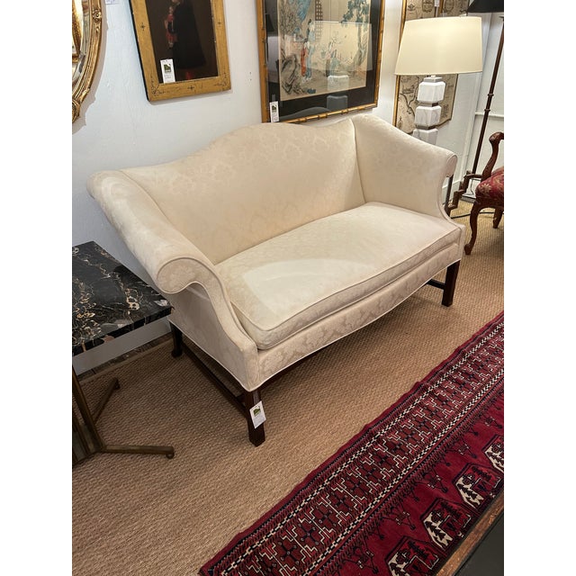 Classic Chippendale style vintage upholstered sofas loveseats having walnut legs and stretcher and cream damask. The...