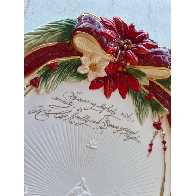 Fitz and Floyd Poinsettia Trim serving platter. The platter features a festive design with a poinsettia rim, pine boughs,...