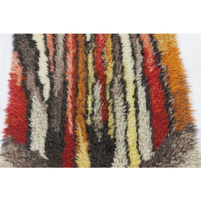 Hand-knotted in lush, high-pile wool in Sweden circa 1960-1970, this 2x4 vintage Swedish Rya runner rug is a bold new...