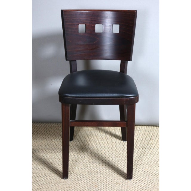 Set of six art deco style chairs in solid wood, the backs are openwork and the seats are covered in black imitation...