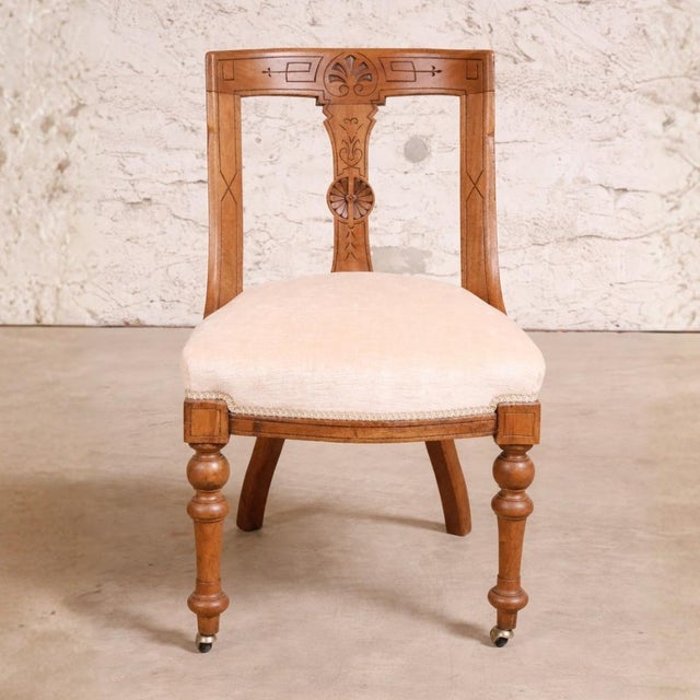 This set of four 20th Century English Walnut Carved Back Dining Chairs showcases refined craftsmanship and timeless...