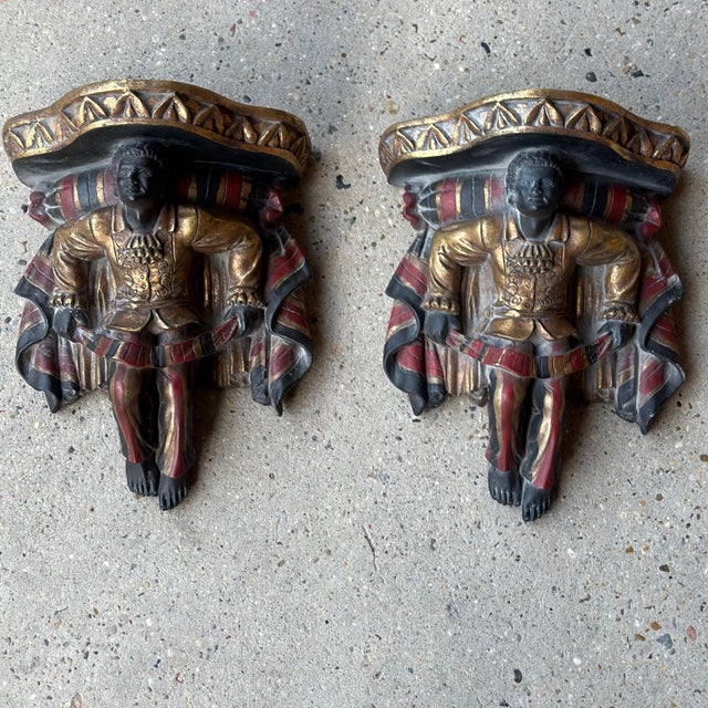 A striking pair of Venetian-style wall brackets, cast in resin and finished in richly detailed polychrome to capture the...