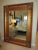 Beveled floor mirror featuring a wood frame with carved leaves and berries on each corner and a bronze finish. Hardware on...