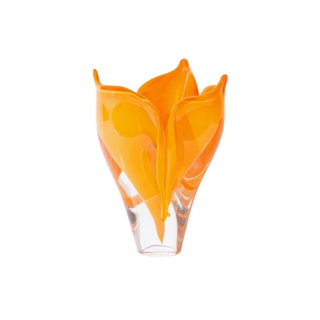A 2006 art glass vase by American artist Steven Webber. This piece is a vibrant orange and is in the shape of a flower in...