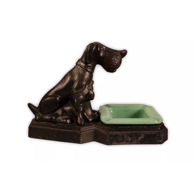 A classic Art Deco metal sculpture depicting three sitting dogs with a vintage jadeite bowl. Circa 1930s. The item could...