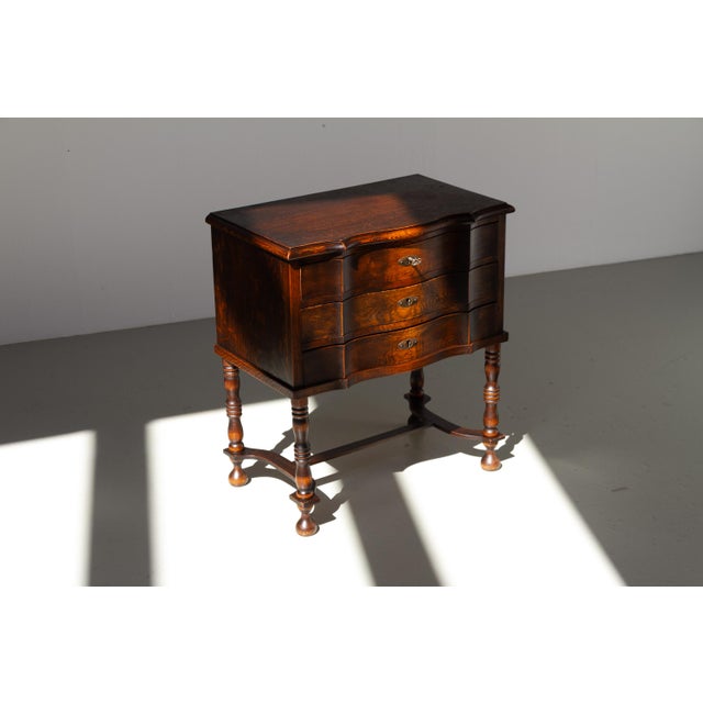 Antique Danish Oak Chest of Drawers, 1910s. Small Rococo style commode with three serpentine front drawers and four turned...