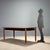 Vintage 1960s table with a beech wood structure, characterized by a simple and elegant design. The aluminum tips add a...