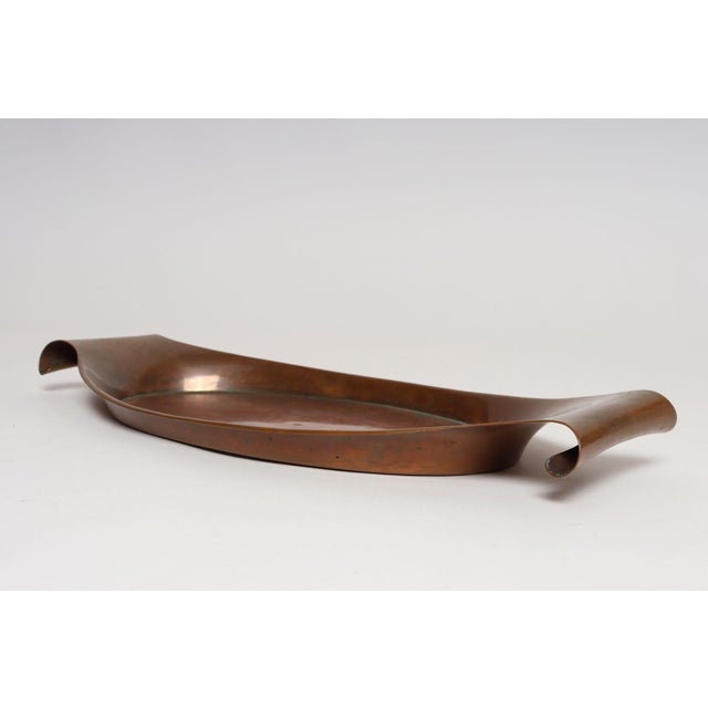 Sculptural Arts & Crafts copper oval/gondola-form tray with scroll handles attributed to William Arthur Smith Benson...
