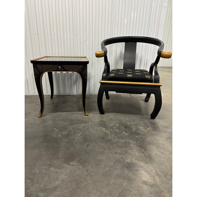 Offered is a modern black Ming style accent chair with gold tipped accents on the arms. Upholstery is a complimentary...