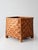 A vintage 1970s woven bamboo storage basket featuring an intricate geometric herringbone pattern in alternating shades of...