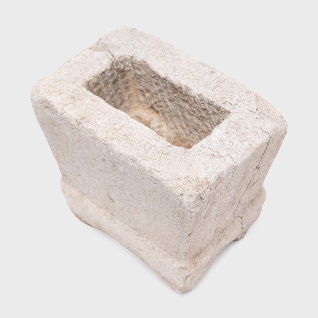 Hand-carved from a solid block of limestone, this small stone vessel is an antique Chinese incense burner from the 19th...