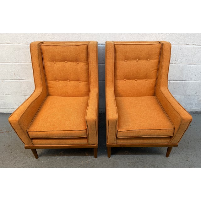 Add a bold mid-century modern touch to your space with this stylish matching pair of vintage upholstered armchairs. Both...