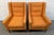 Add a bold mid-century modern touch to your space with this stylish matching pair of vintage upholstered armchairs. Both...