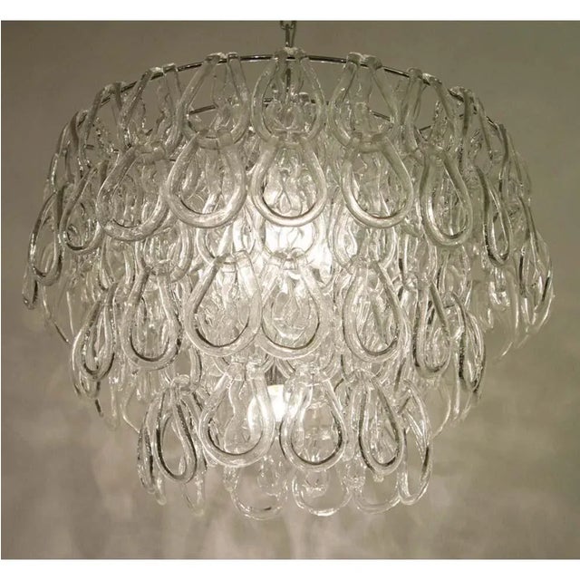 Italian design. Hand-blown clear glass with “hooks” components on chromed steel structure and 5 light bulbs. Up to 250V...