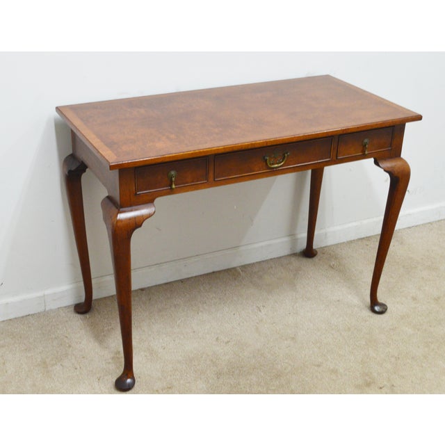 Writing Desk by Kittinger. Store item #554. It features banded top and three dovetailed drawers.