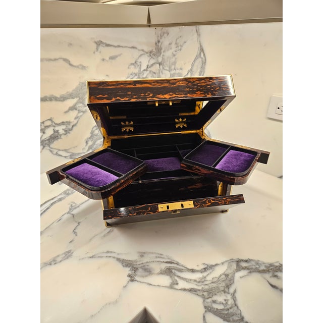 This perfect jewelry casket fabricated in Coromandel wood was manufactured by a famous Austrian manufacturer of leather...
