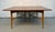 A beautifully crafted mid-century modern walnut dining table featuring a clean, timeless silhouette and a functional...