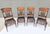 These are four antique pressed back spindle dining chairs, made of oak, are estimated to be from the late 1800s. The top...