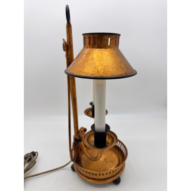 This is a vintage Italian gold-gilded metal bouillotte-style double-light table lamp featuring two candle-form fixture...
