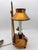 This is a vintage Italian gold-gilded metal bouillotte-style double-light table lamp featuring two candle-form fixture...