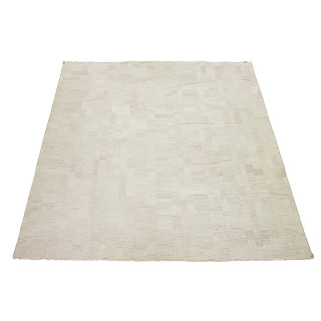 This rug showcases a splendid contemporary Kilim flatweave organic style crafted from premium wool. Its beige color scheme...