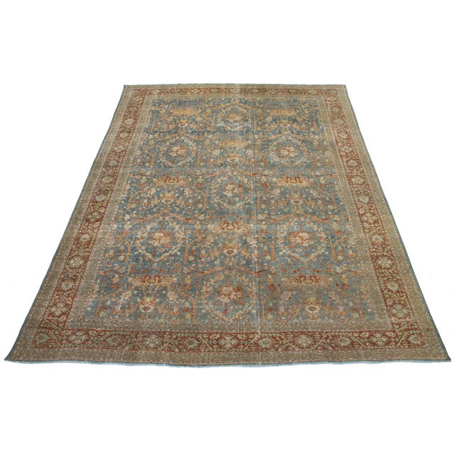 This stunning antique Persian Tabriz rug from the 1910s features a vibrant blue field with an intricate floral pattern,...