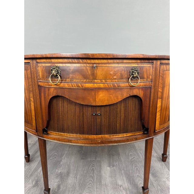 An elegant 19th-century mahogany and mahogany veneer half-moon buffet. Its distinctive half-moon shape beautifully...