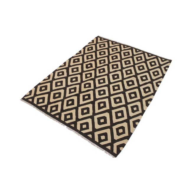 "Add a touch of elegance to your home with this casual chic hand woven Tribal Kilim Hand-Woven Wool Rug. Constructed on a...