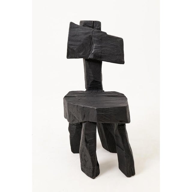 This striking chair is a unique functional sculpture, carved from solid hardwood to ensure absolute structural permanence...
