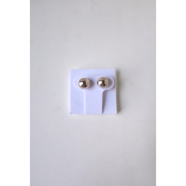 A beautiful pair of sterling silver ball bead stud earrings, in the style of Tiffany & Co., circa late-20th century. Each...