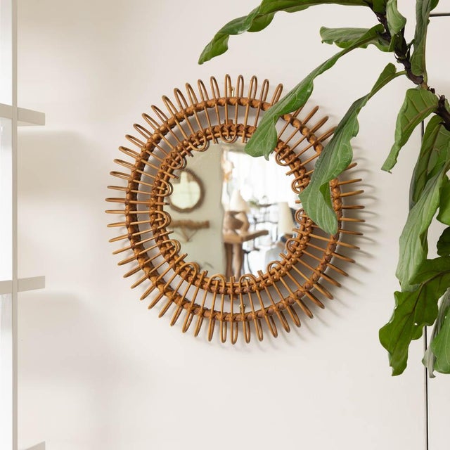 Beautiful rattan mirror in an circular shape from Italy, 1960s. Unique design with looped rattan detailing encompassing...