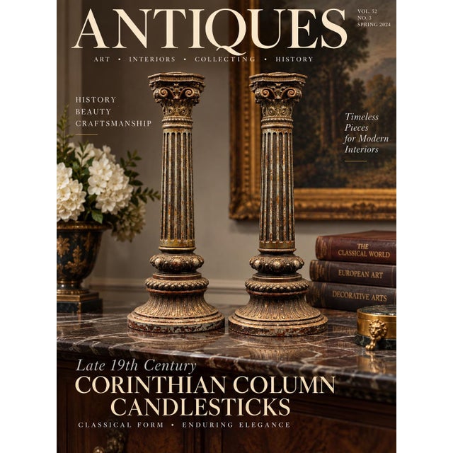 A pair of patinated metal candlesticks cast in the form of Neoclassical Corinthian columns featuring fluted shafts, ornate...