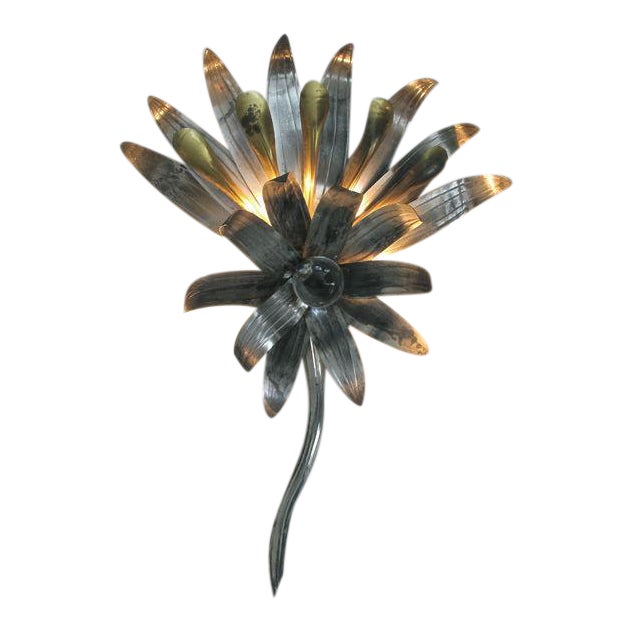 A stylish pair of American art deco tole and brass foliate-form sconces centering glass spheres; each lively form...