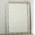 A French 19th century Louis Philippe mantel mirror with an understated, silver gilt frame enhanced by dark oxidation and...