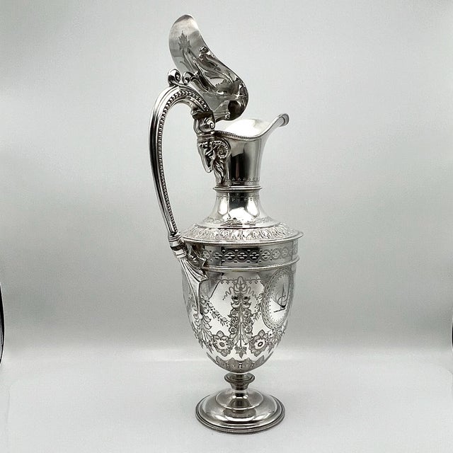 This richly decorated victorian claret jug is crafted in electroplated silver by james deakin & sons, one of sheffield’s...