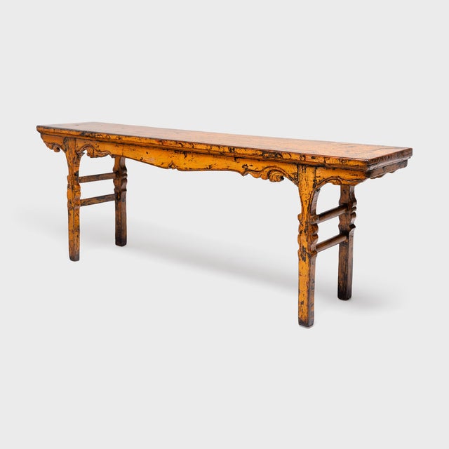 This antique Chinese offering table stands out for its grand scale, sculptural shape and vibrant finish of marigold-orange...