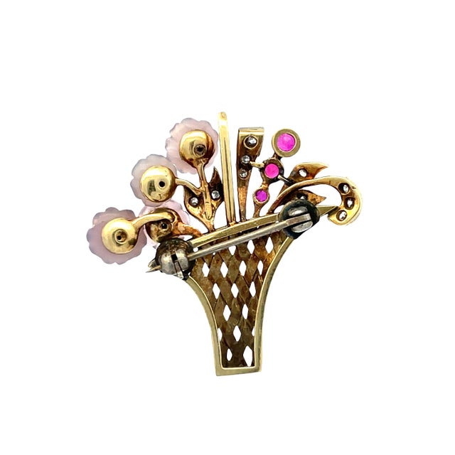 Elegant vintage brooch crafted in solid 14K yellow gold, designed as a floral bouquet motif. Weight: 5.3gm. Accented with...