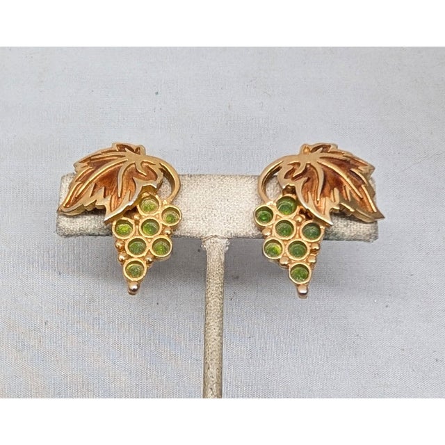 1960s goldtone green and orange enamel grape cluster clip earrings. Marked "NAPIER PAT. PEND." on the clips. Measure: 1...