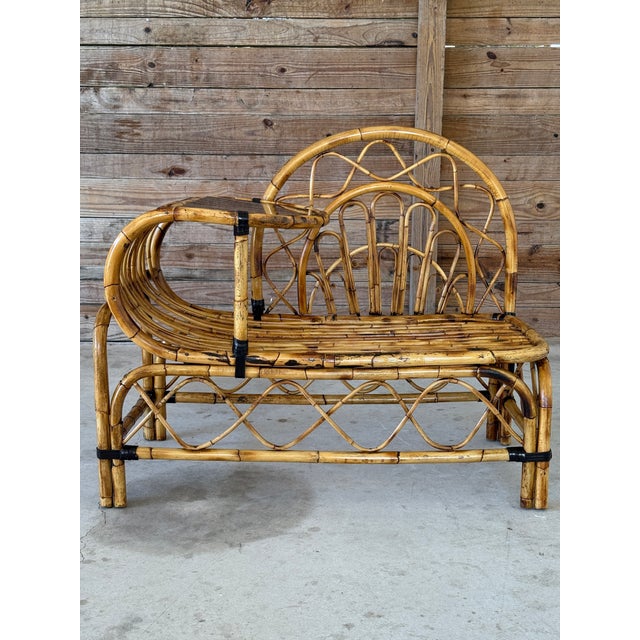 Charming mid-century bent rattan telephone seat or bench, restored to highlight its warm patina while preserving its...