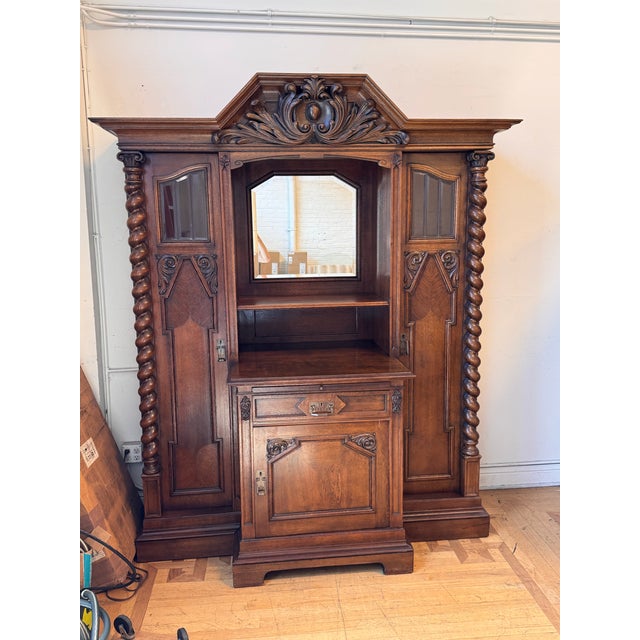 Design Plus Gallery presents a 19th Century French Henry II Style Oak Hunt Cabinet. This antique cabinet displays...