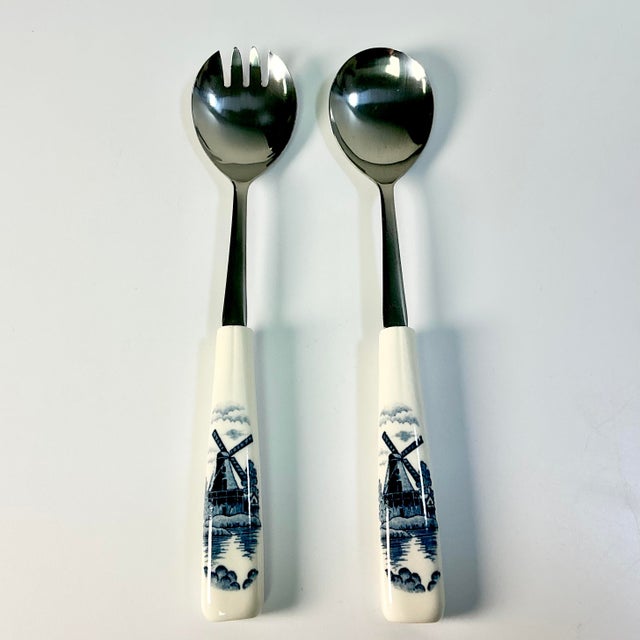 This is a delightful set of Salad Serving Utensils with Delft style painted handles. The fork and spoon art stainless...