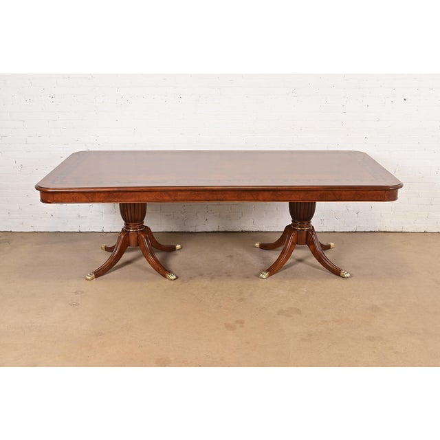 An exceptional Italian Regency style double pedestal dining table In the manner of Baker Furniture USA, Circa Late 20th...