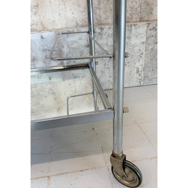 A fabulous drinks trolley made from chrome and mirrored glass with a bottle holder dating from the middle of last century....