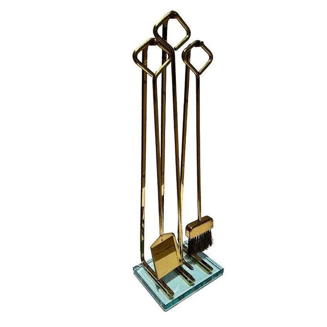 Elegant modern fireplace tool set by Fontana Arte, circa 1970’s. The set includes a shovel, poker, and broom. Original...