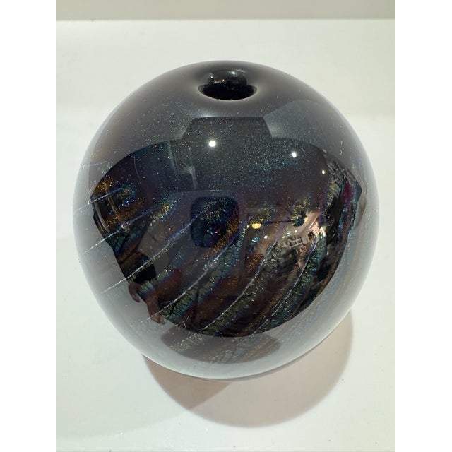 Signed Robert Eickholt studio art glass bud vase dated 1984, featuring a rounded form with a narrow top opening and richly...