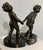 Pair of bookends. Metal alloy cushions on marble with bronze artist's stamp on the base.