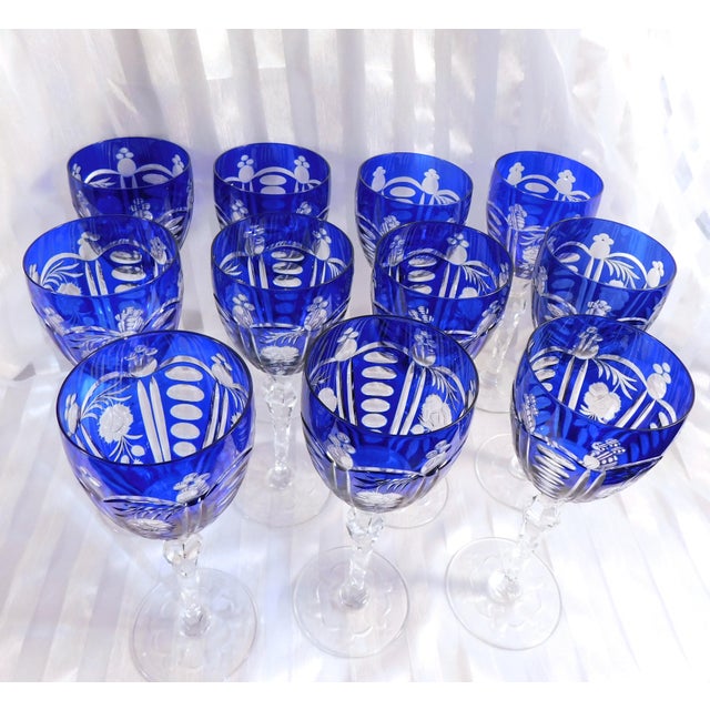 This is a set of eleven matching blue cut to clear wine glasses or stemware glasses. There are no markings on any of the...
