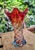Murano glass vase, with brand. Tones of red, orange, blue and transparent. Reminiscent of a drop that touches a surface...