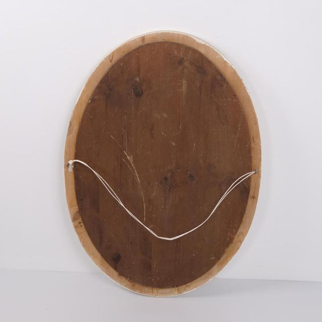 Oval mirror with a white-painted wooden frame dating from the 1940s. It features a simple classic design suitable for a...