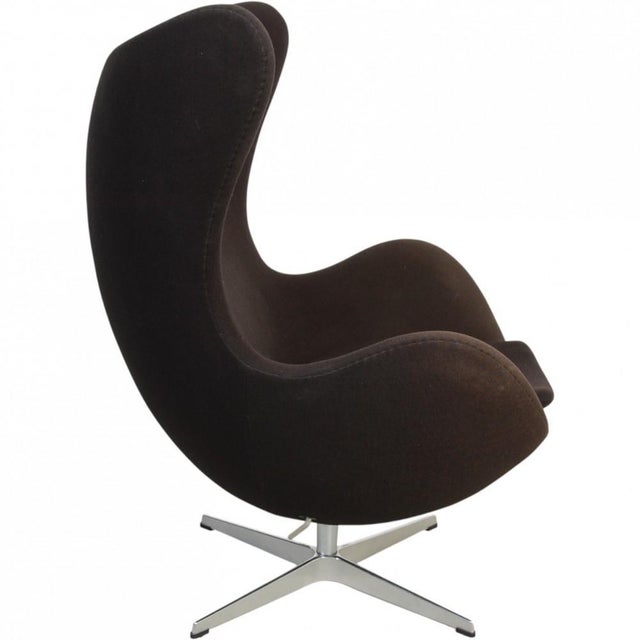 Arne Jacobsen Egg chair upholstered in original black fabric, and with a base of brushed aluminium. The chair is from 2012...